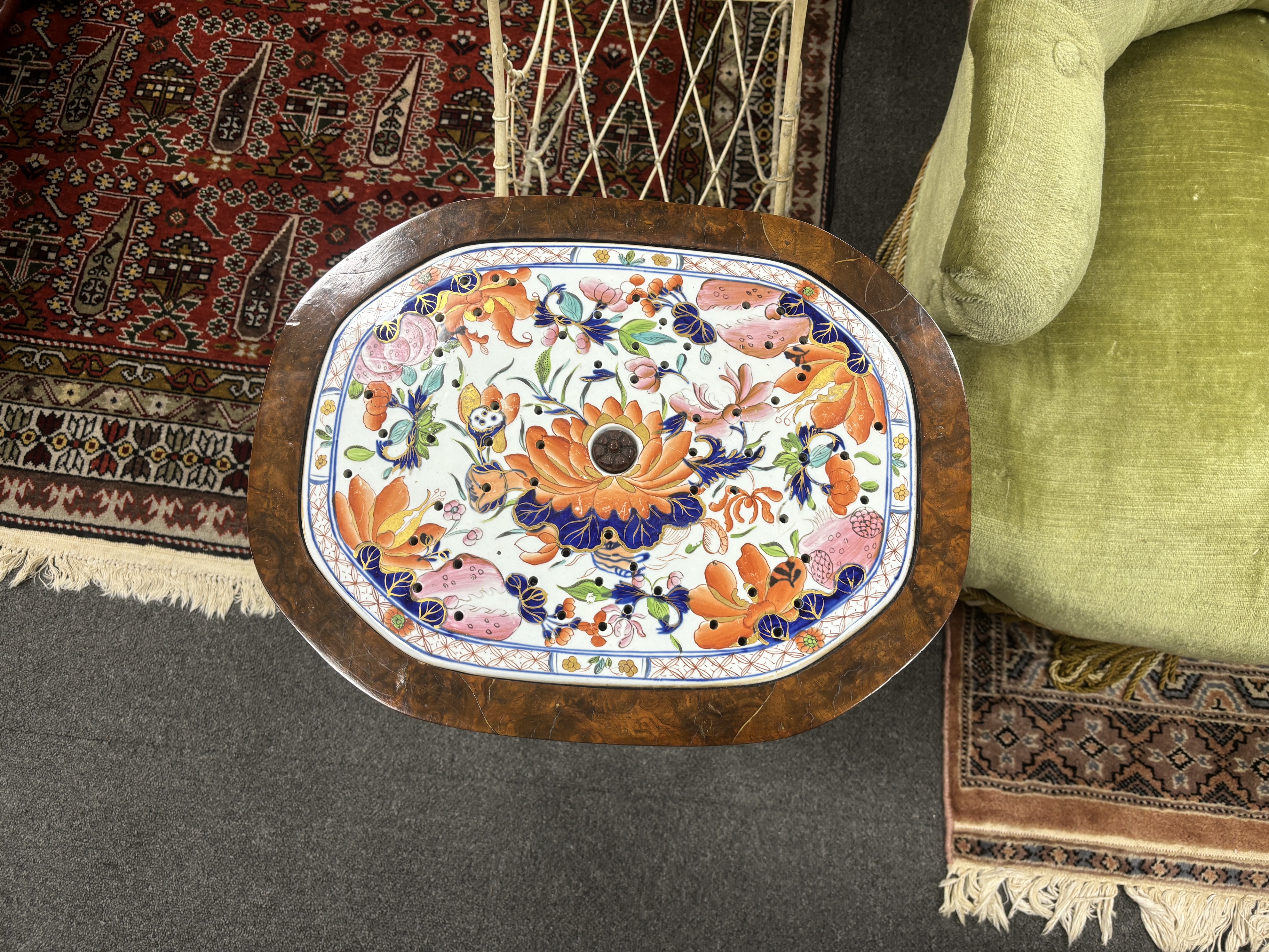 A pair of American walnut tables, each inset with Mason’s ironstone strainer panels, 47cm high